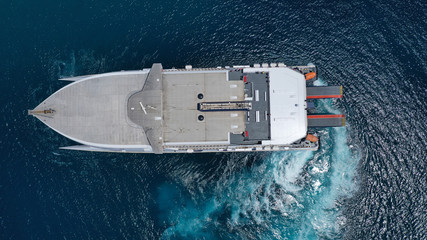 Aerial drone top view photo of high speed passenger ferry arriving at port of Mykonos island,...