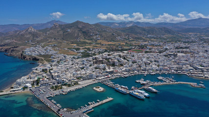 Aerial drone photo of iconic port of Naxos island featuring uphill castle and beautiful Temple of Apollon or Gate, Cyclades, Greece - obrazy, fototapety, plakaty