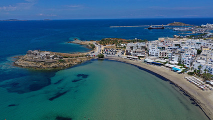 Fototapeta na wymiar Aerial drone panoramic photo of famous turquoise sea sandy beach of Saint George next to chora main town of Naxos island with beautiful uphill castle, Cyclades, Greece