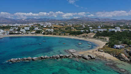 Fototapeta na wymiar Aerial drone photo of breathtaking turquoise round sandy beach and small village and small seaside picturesque chapel of Agia Anna, Naxos island, Cyclades, Greece