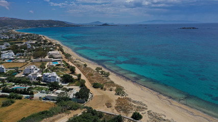 Aerial drone top view photo of breathtaking turquoise sandy beach of Plaka with sun beds and umbrellas, Naxos island, Cyclades, Greece