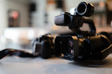 Professional video camera on the table at the cafe studio