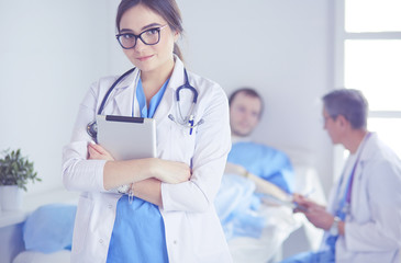 Female doctor using tablet computer in hospital lobby