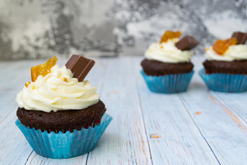 Chocolate cupcakes with vanilla butter frosting and golden crumbs, chocolate, and lemon. There is a memo for the text.