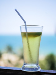 a glass of cocktail standing on a sky background