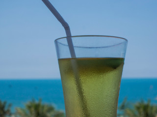 a glass of cocktail standing on a sky background