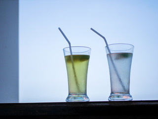 two glasses of cocktail standing against the sky