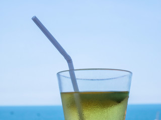 a glass of cocktail standing on a sky background