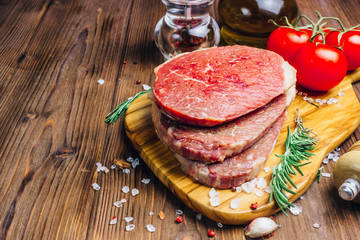 Fresh raw Black Angus beef steak on wooden board