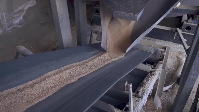 Sand is delivered by conveyor. Sand on the conveyor