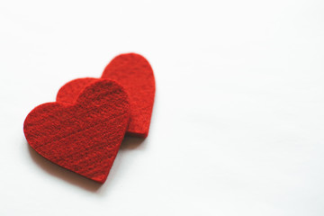 Red felt hearts on a white background. Valentine's Day