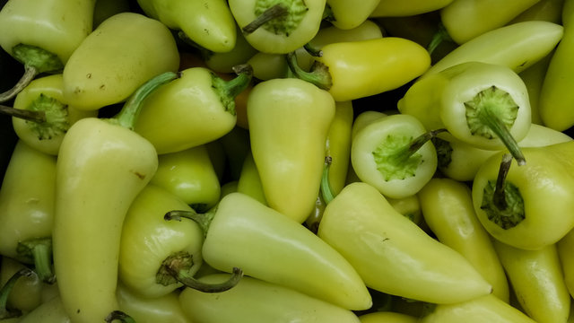 Detailed heap of hot Caribe chili peppers, also named yellow chili peppers or chile guero in Mexico. 