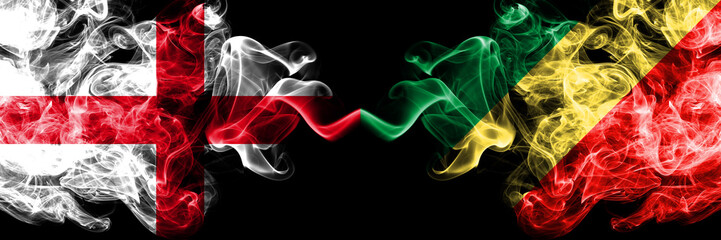 English vs Congo, Congolese smoky mystic flags placed side by side. Thick colored silky smokes flag of England and Congo, Congolese.