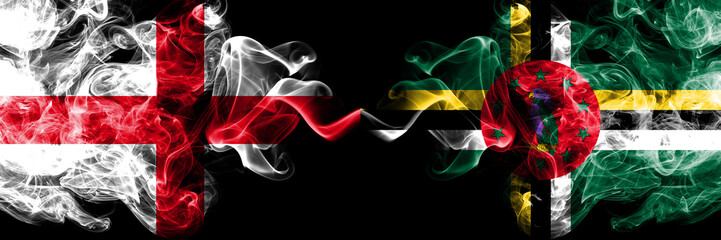 English vs Dominica smoky mystic flags placed side by side. Thick colored silky smokes flag of England and Dominica.