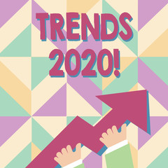 Handwriting text Trends 2020. Conceptual photo general direction in which something is developing or changing photo of Hand Holding Colorful Huge 3D Arrow Pointing and Going Up