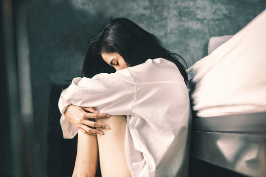 Depress Asian Woman Sitting In Bedroom Feeling Lonely And Sad 