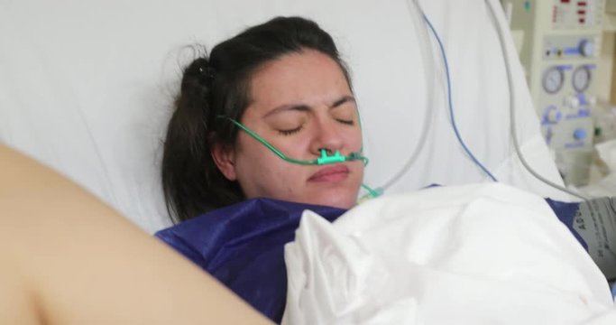 Woman in hospital giving birth pushing baby in labor, real life pregnancy in delivery room
