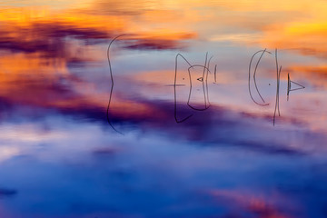 Lake and reeds. Abstract sunset nature background. Long exposure technique.