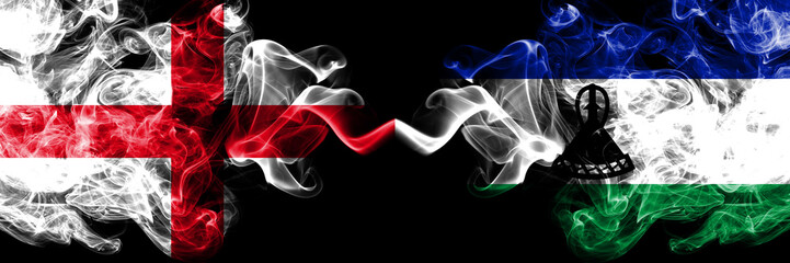 English vs Lesotho smoky mystic flags placed side by side. Thick colored silky smokes flag of England and Lesotho.