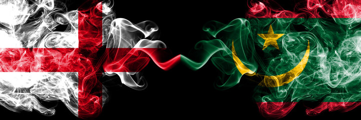 English vs Mauritania, Mauritanian smoky mystic flags placed side by side. Thick colored silky smokes flag of England and Mauritania, Mauritanian.