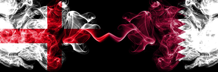 Obraz premium English vs Qatar, Qatari smoky mystic flags placed side by side. Thick colored silky smokes flag of England and Qatar, Qatari.