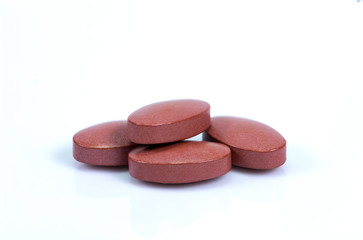 Closeup pink medicine pill isolated on white background.