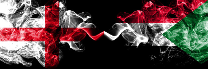 English vs Sudan, Sudanese smoky mystic flags placed side by side. Thick colored silky smokes flag of England and Sudan, Sudanese.