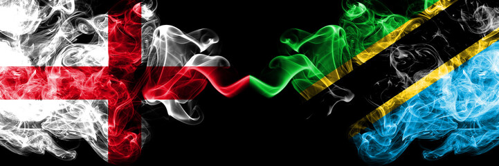 English vs Tanzania, Tanzanian smoky mystic flags placed side by side. Thick colored silky smokes flag of England and Tanzania, Tanzanian.
