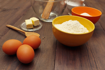 Traditional ingredients for making dough on a wooden table.