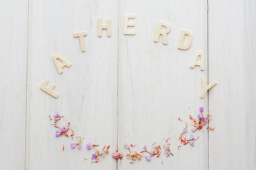 The word "Father's Day" on a white wooden table