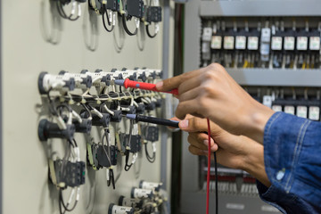 Electrician engineer work  tester measuring  voltage and current of power electric line in...