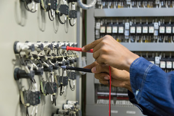 Electrician engineer work  tester measuring  voltage and current of power electric line in...