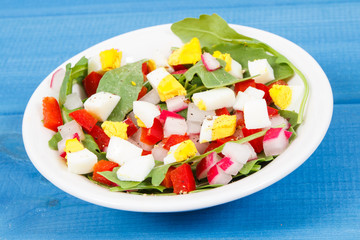 Fresh salad in glass bowl on boards, dieting and healthy nutrition concept