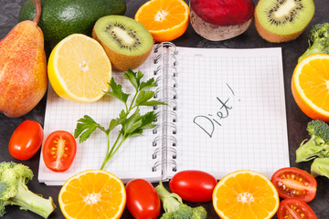 Word diet written in notepad and fresh fruits with vegetables, healthy lifestyles and nutrition