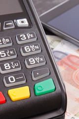 Obraz premium Payment terminal, money and smartphone with NFC technology using for cashless paying