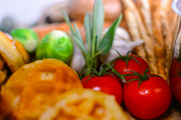 One bunch of fresh tomatoes with various breads Blurred images in front of the focus on tomatoes
