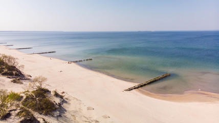 Air shot. Beautiful view of a sandy beach with old breakwaters and and blue sea
