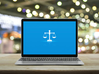 Law flat icon with modern laptop computer on wooden table over blur light and shadow of shopping...