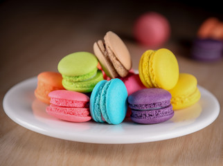 Fototapeta na wymiar Colorful macaroons. Sweet macarons on dark background