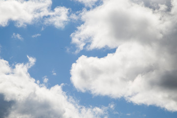 White sparse clouds over blue sky 
