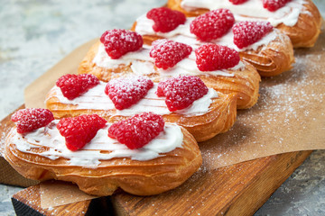Cake eclair. Gray textured background. Beautiful serving dishes. Dessert. Food chain