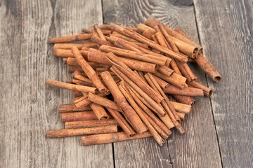 Cinnamon sticks isolated on brown wooden background.