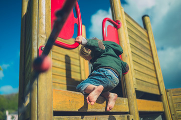 Little toddler climbing at the playgrund