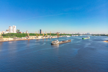 Naklejka premium Scenic view of the city by the river with ships sailing on it. Concept clean city, life in the city. aerial shot, top shot