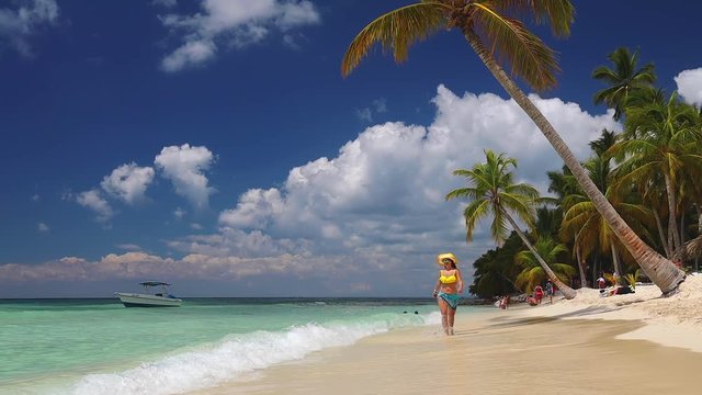 Happy carefree woman enjoying summer vacation in Saona Island and caribbean beaches, Dominican Republic