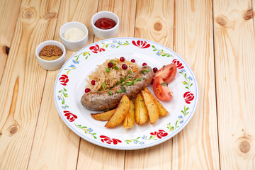 sausage with baked potatoes and sauce