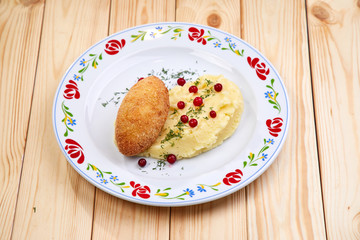 cutlet with mashed potatoes on the wooden background