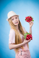 Young woman holding radish