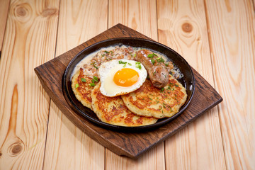 potato pancakes with egg and sausage