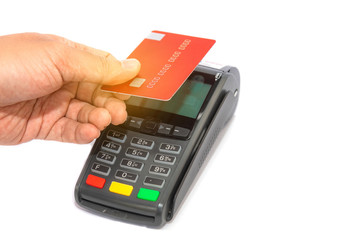 Hand holding a credit card give for cashier at counter with credit card machine to payment shopping.